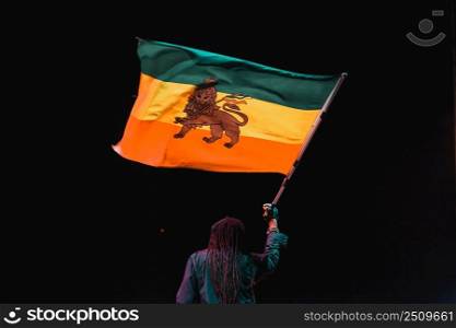 black man waving jamaica flag