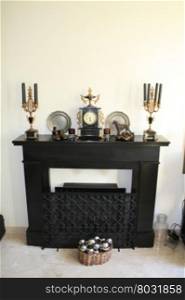 Black marble fireplace with antique clock and matching candleholders