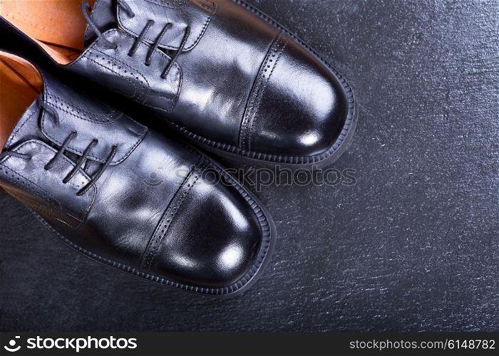black men&rsquo;s shoes on dark background
