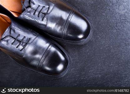 black men&rsquo;s shoes on dark background