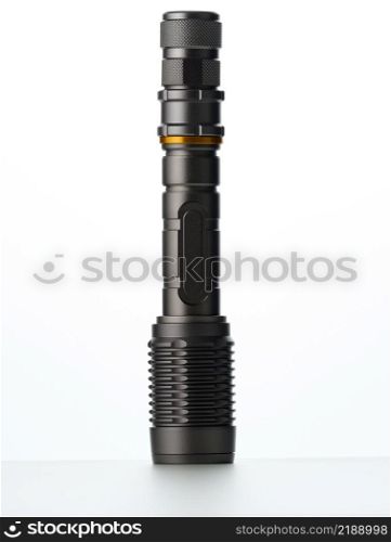 black metal portable flashlight isolated on white background