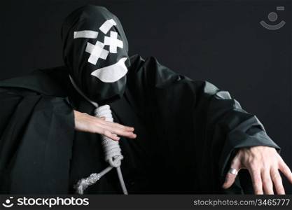 Black mime with rope on neck on black background