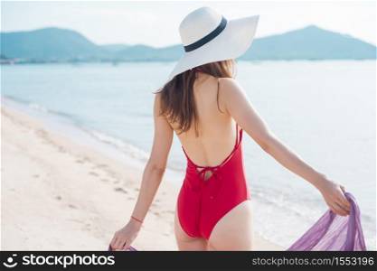 Black of beautiful woman in red swimsuit on the beach