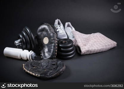 black older punch pads for boxing training with accessories on dark background