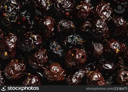Black olives with paprika and thyme covering the entire screen for background use