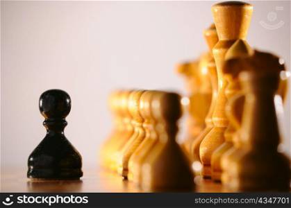 black pawn against white chess pieces army