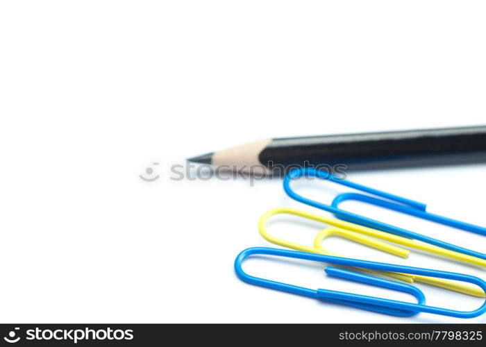 black pencil and colored paper clip isolated on white