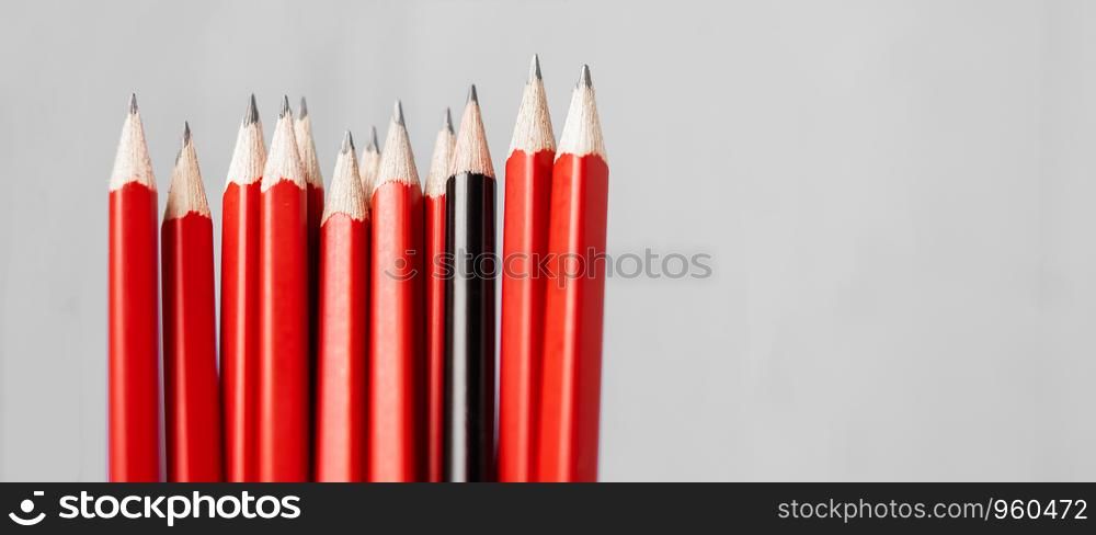 Black pencil different from crowd of red pencils. Unique Leader, strategy, independence, think different, business and success concept