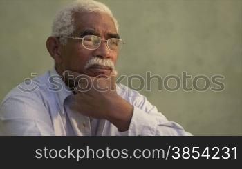 Black people and emotions, portrait of depressed senior man with glasses looking away. Sequence