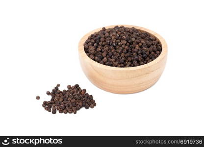 black peppercorns in wooden bowl isolated on white background