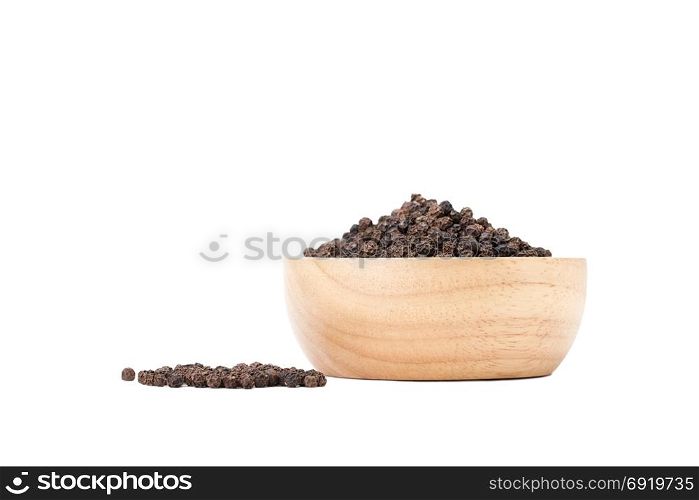 black peppercorns in wooden bowl on white background