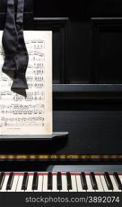 Black Piano with Sheet Music and Bow Tie