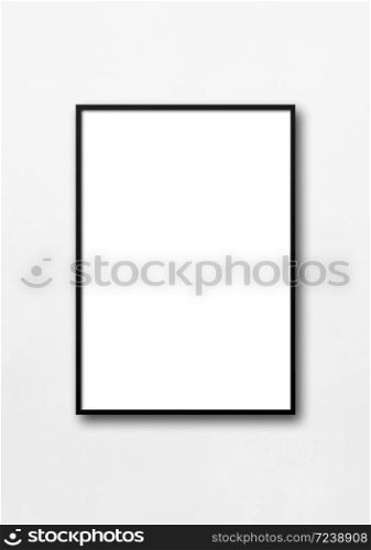 Black picture frame hanging on a white wall. Blank mockup template. Black picture frame hanging on a white wall