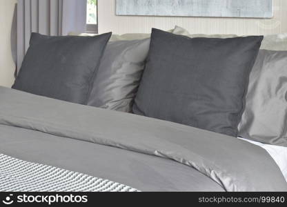 Black pillows on bed in gray color scheme bedding