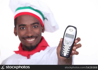 black pizzaiolo holding out phone