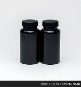 Black plastic pill jars on a white background. Isolated. plastic pill jars