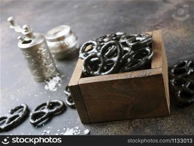black pretzels in wooden bowl on a table