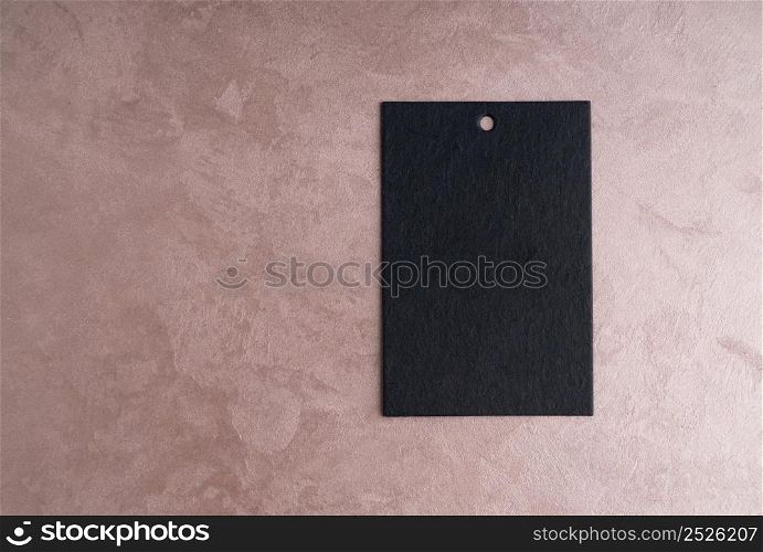 black price tag isolated on decorative textured background. top view. the label on ornamental background