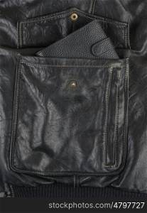 black purse in a pocket of black leather jacket