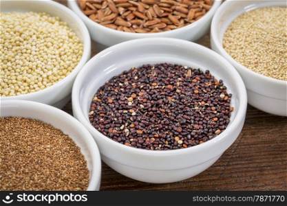 black quinoa and other gluten free grains (amaranth, millet, teff brown rice) in small ceramic bowls