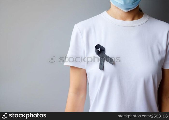 black Ribbon for Melanoma and skin cancer, Vaccine injury awareness month, grief and rest in peace. Healthcare and Racist concept