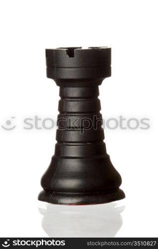 Black rook chess piece isolated on white background with reflection on the floor