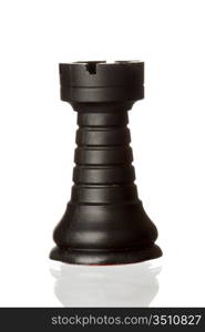 Black rook chess piece isolated on white background with reflection on the floor