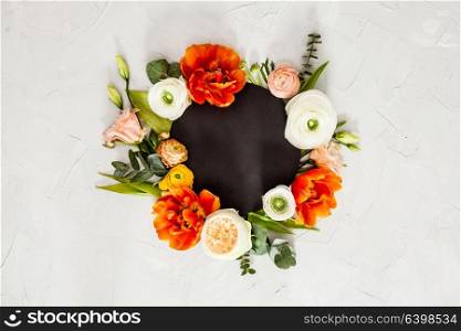 Black round card with beautiful flowers, leaves and copy space. Holidays greetings. Floral layout with copy space
