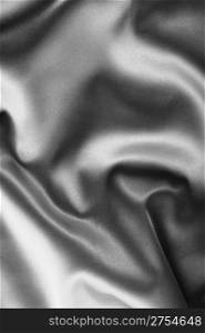 black satin background. A satiny fabric with beautiful light-shadow waves