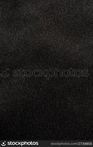 Black satin fabric background closeup.