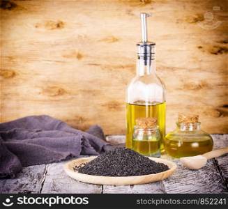 black sesame and oil on old wooden background