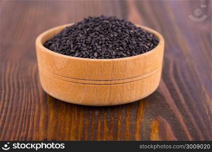 black sesame in a Cup on wooden surface