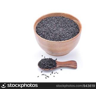 black sesame seeds in wooden bowl isolated on white background