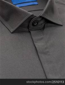 black shirt with focus on collar and button, close-up. cotton shirt, close-up