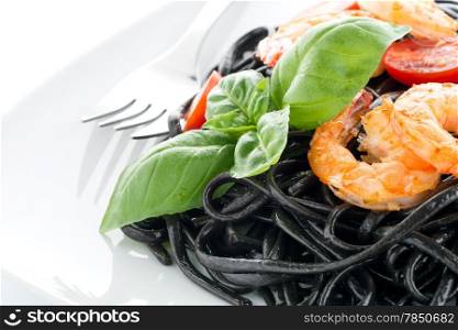 Black spaghetti with shrimps isolated on white