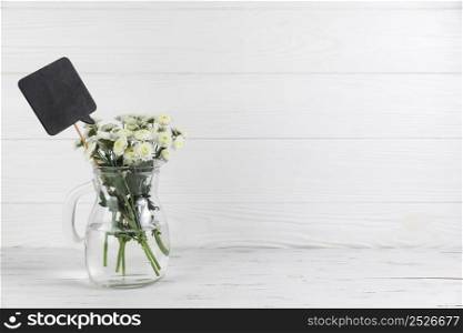 black speech bouquet chrysanthemum flowers glass jar white wooden table