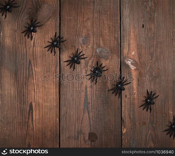 black spider figurines on brown wooden background, Halloween holiday