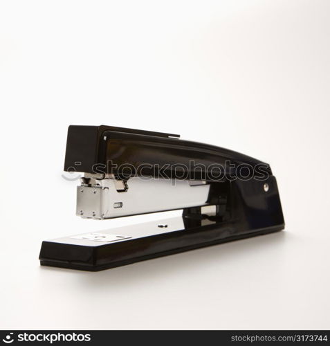 Black stapler on white background.