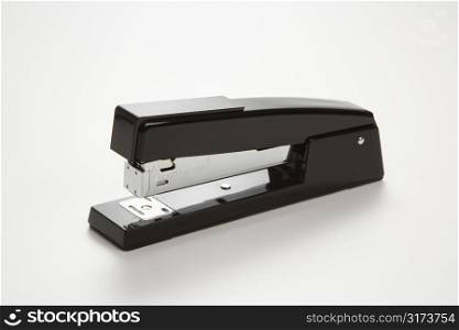 Black stapler on white background.
