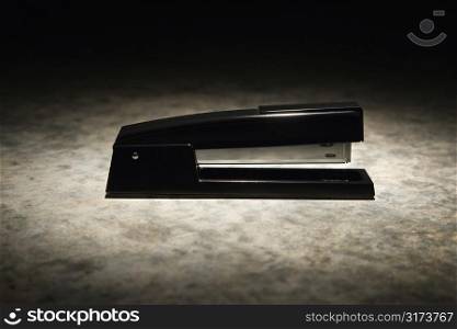 Black stapler with black vignette.