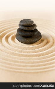 Black stones pile in the sand. Zen japanese garden background scene. Zen japanese garden and black stones background