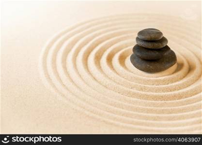 Black stones pile in the sand. Zen japanese garden background scene. Zen japanese garden and black stones background