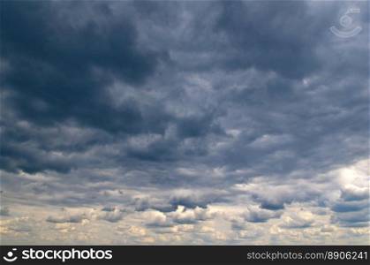 Black storm clouds and bright horizon in sky.