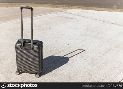 black suitcase travelling street