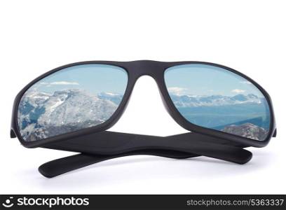 Black sunglasses with mountain reflection on isolated white background. Winter sports or vacation concept.