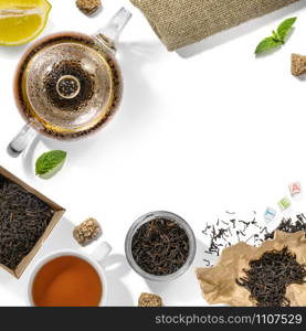 Black tea and accessories top view on white background.. Black tea and accessories top view on white background