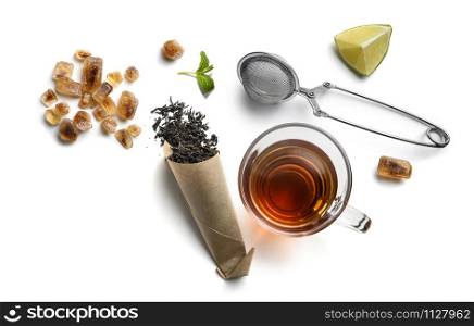 Black tea and accessories top view on white background.. Black tea and accessories top view on white background