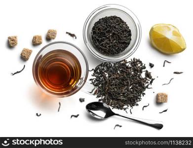 Black tea and accessories top view on white background.. Black tea and accessories top view on white background