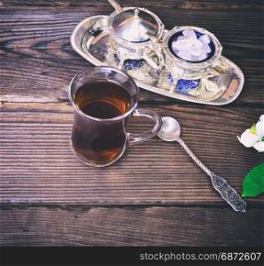 Black tea in a glass Turkish glass on a wooden table