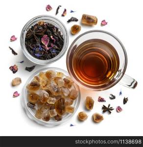 Black tea with natural flavors and a cup. Top view on white background.. Black tea with natural flavors and a cup. Top view on white background